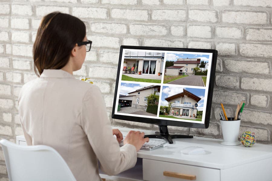 realtor browsing real estate photos in computer